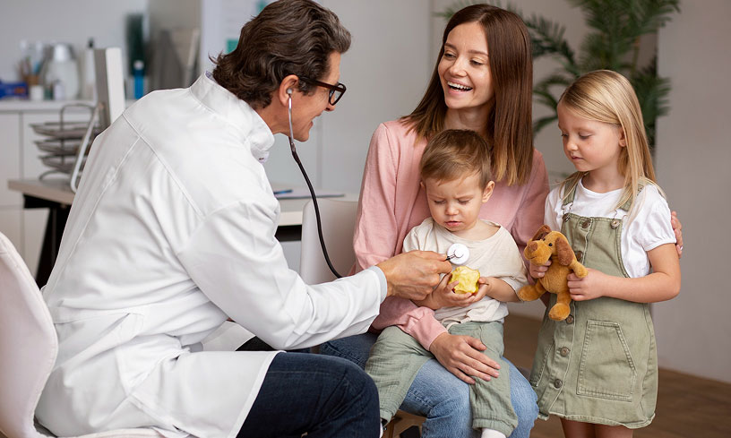 Direct Primary Care doctor performing a wellness exam for a baby with family at Primary Health Partners